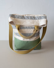 Load image into Gallery viewer, The top folds down to create a flap that conceals a generous zippered pocket. (showing the yellow strap handle version).