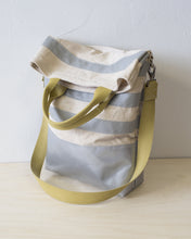 Load image into Gallery viewer, The top folds down to create a flap that conceals a generous zippered pocket. (showing the yellow strap handle version).